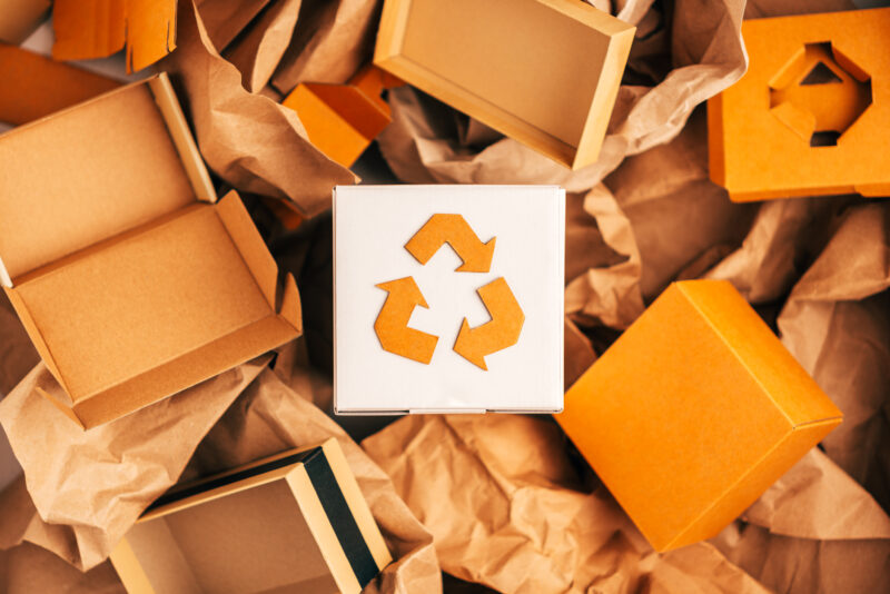 brown recycling symbol surrounded by cardboard boxes zero waste schools